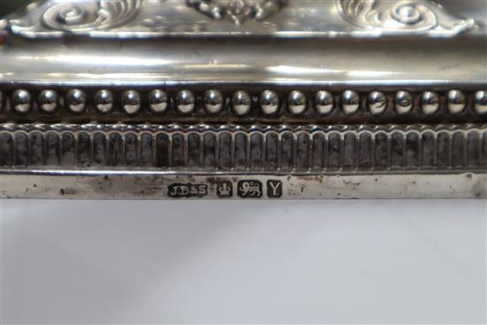 A pair of late Victorian silver corinthian column candlesticks, James Dixon & Sons, Sheffield, 1891 (one sconce a.f.), 27cm.